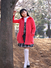 Japanese tramp poses in her school uniform as she waits