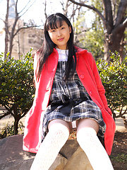 Japanese tramp poses in her school uniform as she waits