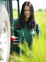 Gwen playfully strips her green shirt matching the green grassy field and poses naughtily all over the jeep, flaunting her awesome physique and gorgeous breasts.