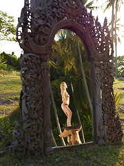 Naked girl photographer photographing her friend in the garden