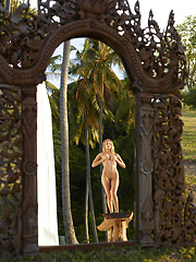 Naked girl photographer photographing her friend in the garden