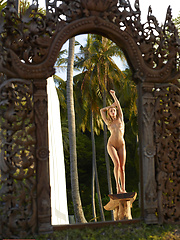 Naked girl photographer photographing her friend in the garden